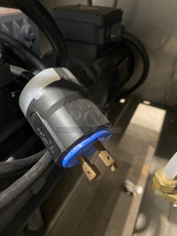 Close-up of electrical plug for Promax stainless steel vacuum tray sealer. Image shows detailed connector with blue tip.