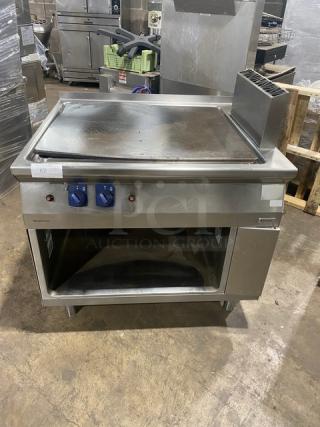 Electrolux Thermaline stainless steel natural gas flat top grill with backsplash, enclosed open base, on legs.