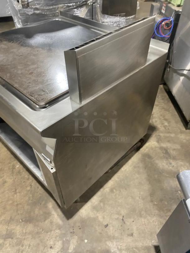 Electrolux Thermaline stainless steel grill with backsplash, enclosed base, on legs. Natural gas powered, commercial-grade.
