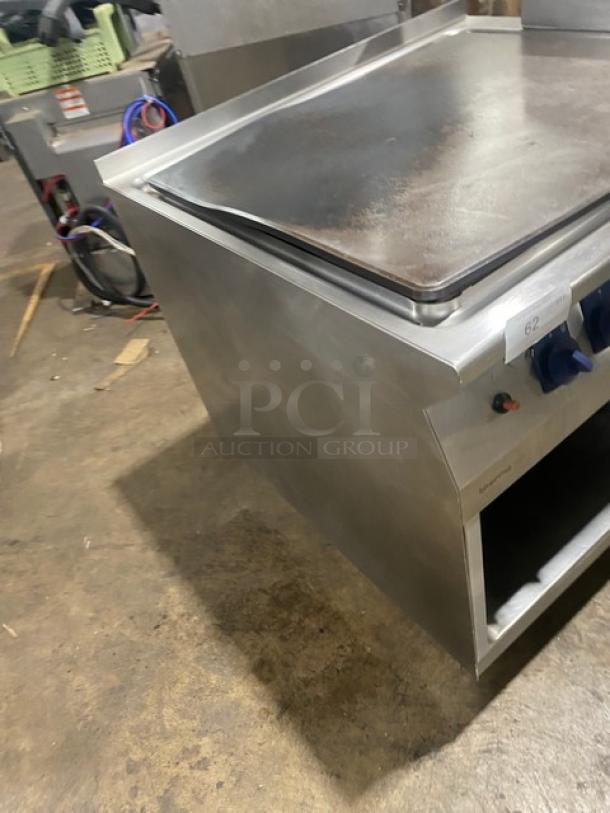 Electrolux Thermaline grill, stainless steel, natural gas, flat top, back splash, enclosed base, on legs, commercial use.