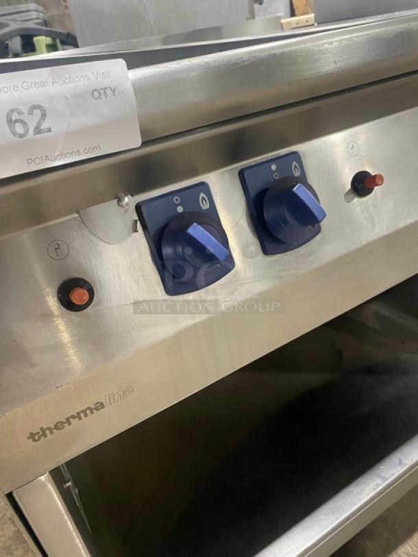 Electrolux Thermaline flat top grill, stainless steel, natural gas, enclosed base, back splash, control knobs visible.