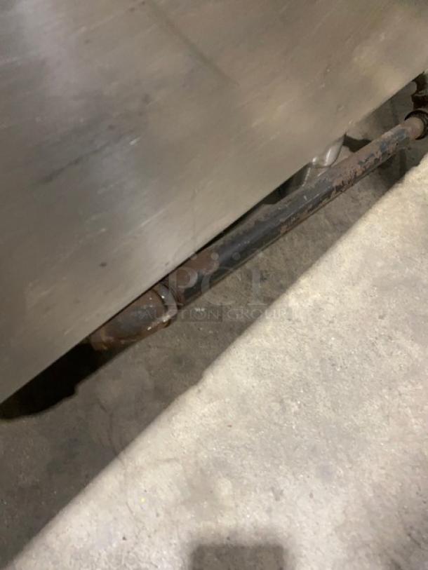 Electrolux Thermaline stainless steel flat top grill, natural gas, with back splash and enclosed open base on legs, showing structural detail.