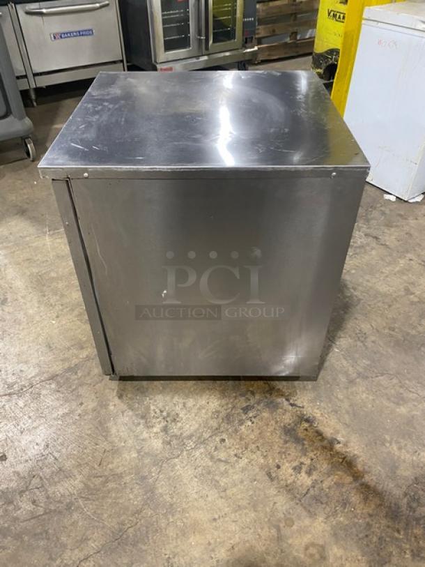 Delfield stainless steel single door undercounter refrigerator, model 406PSTAR2. Equipped with poly coated wire rack, on casters.