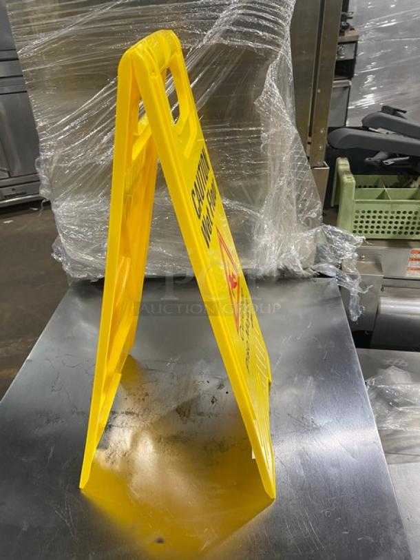 Brand new Update International yellow fold-out wet floor sign, model WFS-25, 24". Caution marking visible.