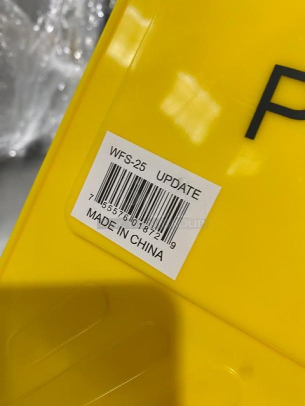 Brand new Update International Model WFS-25 yellow fold-out caution/wet floor sign. Visible barcode and "Made in China" label.