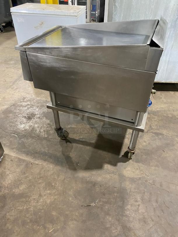 Keating stainless steel natural gas countertop griddle with mirror-shine top, thermostatic controls, splash guards, and cart on casters.