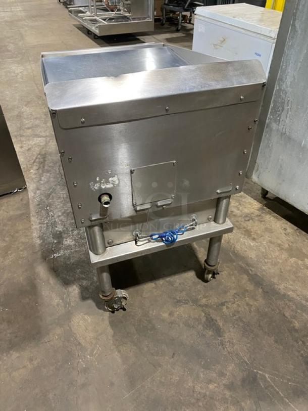 Keating stainless steel natural gas flat griddle with mirror-shine top, thermostatic controls, splash guards, shelf cart on casters.