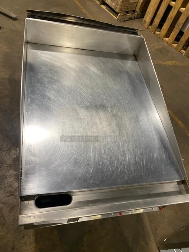 Keating commercial stainless steel gas-powered flat griddle, mirror-shine top, thermostatic controls, back and side splash, on casters.