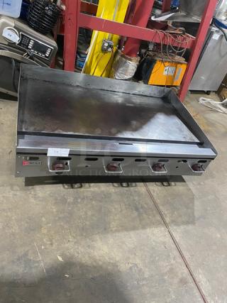 Wolf Regency stainless steel commercial countertop flat top griddle, used condition, four control knobs, visible branding.