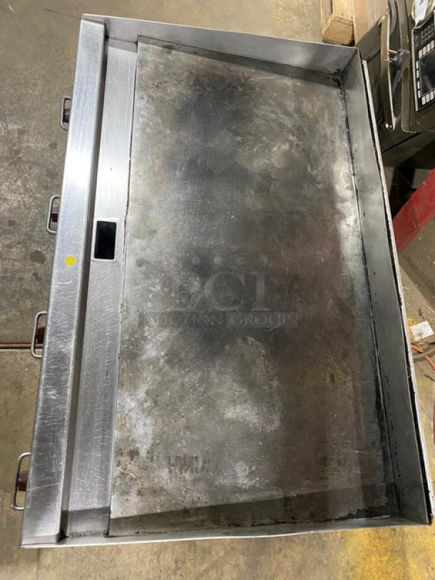 Wolf Regency stainless steel commercial countertop flat top griddle, used condition, visible wear, knobs on the left side.