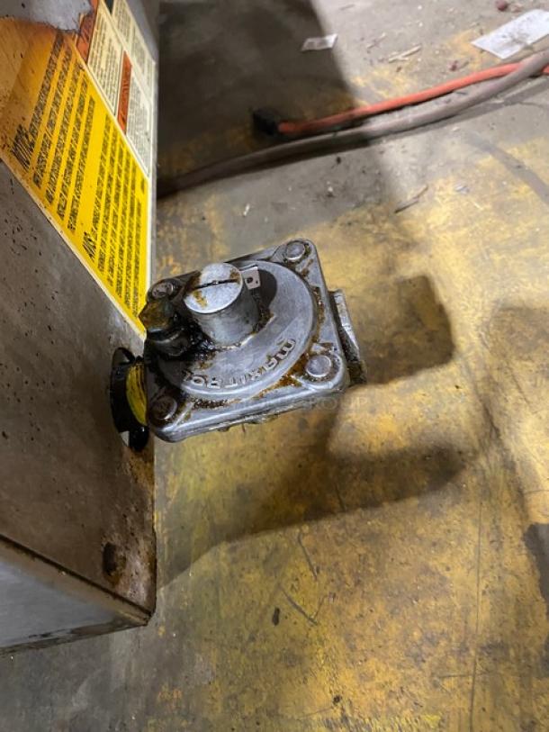 Wolf Regency stainless steel commercial countertop flat top griddle. Used condition with visible wear and labels.