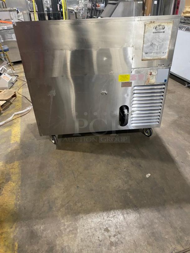 Wasserstrom all stainless steel refrigerated pizza prep table, cold top railing, raised backsplash, 115V, on casters, used.