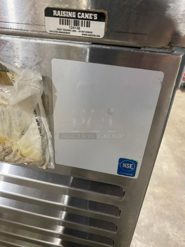 Wasserstrom stainless steel pizza prep table with cold top railing and raised backsplash. NSF certified. On casters.