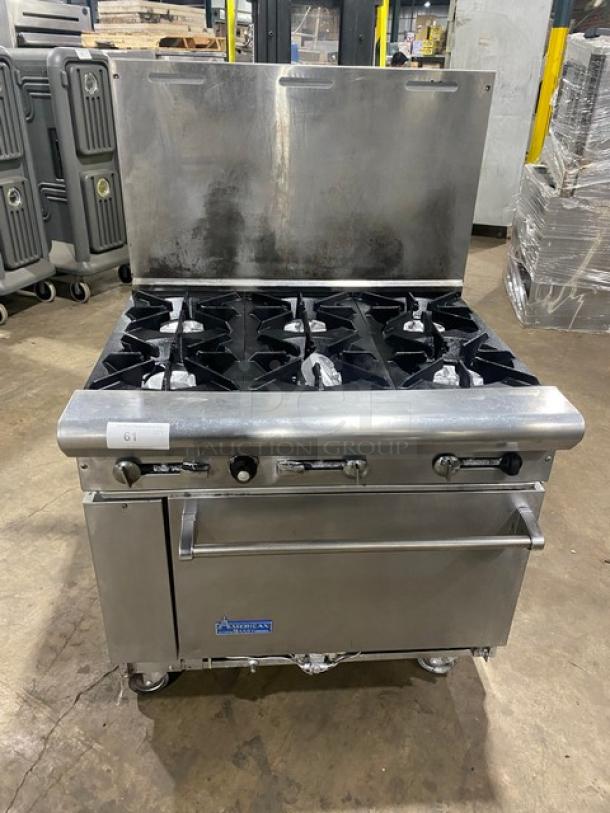 American Range stainless steel 6-burner range/oven combo with backsplash, on casters. Natural gas powered, commercial grade.
