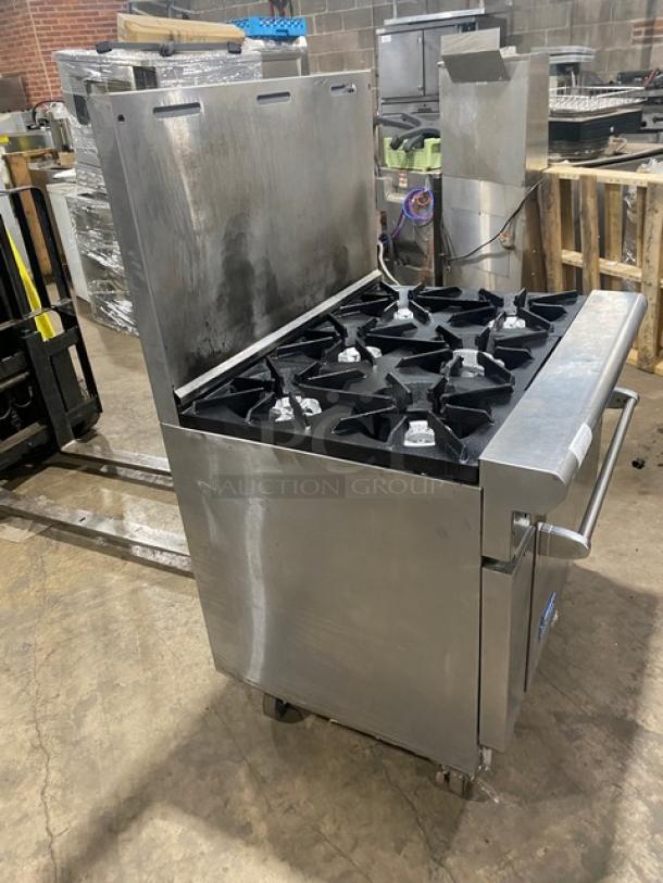 American Range commercial stainless steel 6-burner natural gas stove/oven with backsplash, on casters, in used condition.