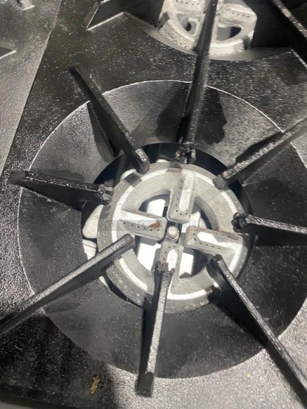 American Range commercial stainless steel 6-burner gas range with oven combo, back splash, on casters, in good condition.