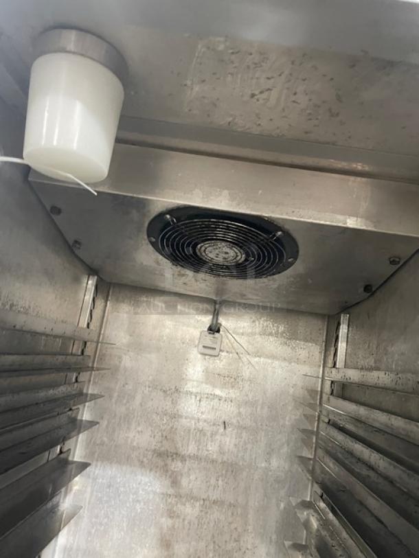 Continental 1R stainless steel single door refrigerator with built-in pan slides and casters, visible interior fan. Model: 1R.