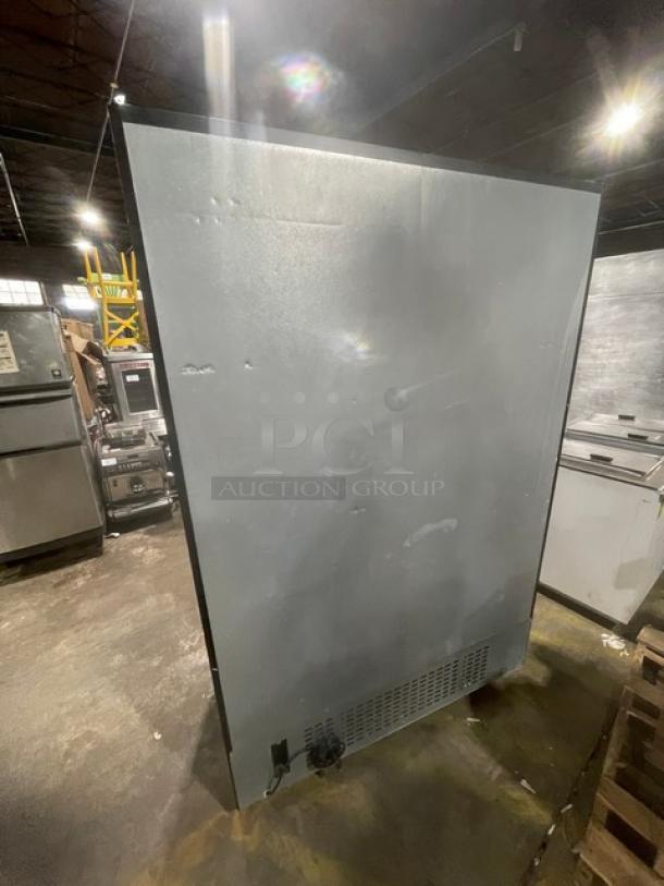 Kool-It KSM-42 commercial refrigerator, black double glass sliding doors, poly coated wire racks, on casters, side view.