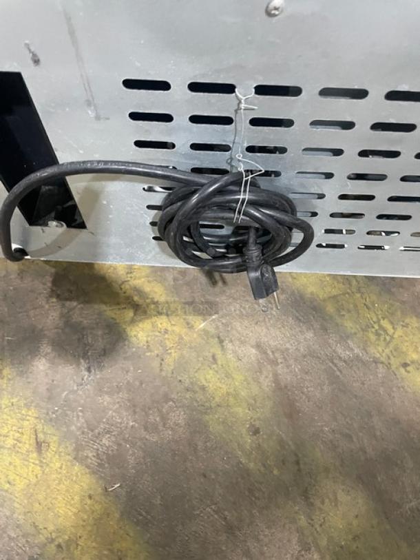 Kool-It KSM42 commercial refrigerator plug and back vent detail. Model KSM42, serial KSM42210902006, 115V, on casters.