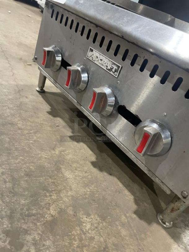 Adcraft CTC24 stainless steel gas char broiler. Features four control knobs and sturdy legs. Branded Adcraft.