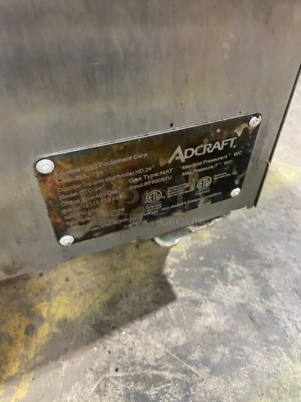 Adcraft CTC24 stainless steel countertop char broiler, natural gas, on legs. Serial number: 12130576005, 80,000 BTU input.