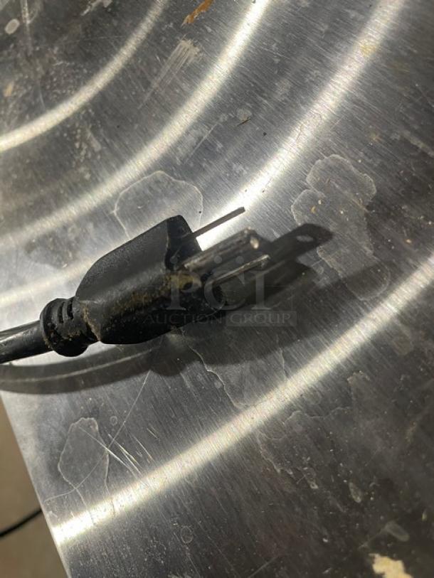 Close-up of a Cooltech CTR-60BM salad prep table plug, highlighting stainless steel surface scratches.