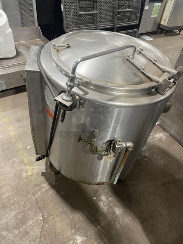 Groen AH/1-40 stainless steel 40-gallon steam jacketed kettle, natural gas-powered, with knob and faucet, on legs.