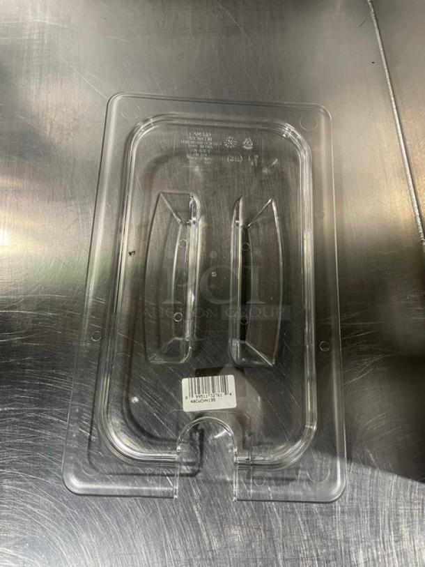Clear Cambro Camwear ¼-size notched food pan lid, model 40CWCHN135, brand new, polycarbonate, marked with product details.