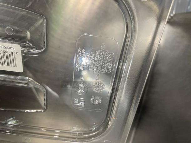 Brand new Cambro Camwear Series clear polycarbonate ¼-size notched food pan lid, Model 40CWCHN135, with visible labeling.
