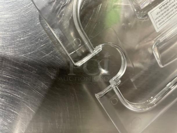 Brand new Cambro Camwear ¼-size clear notched food pan lid, model 40CWCHN135, on stainless steel surface.