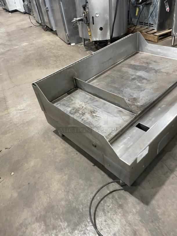 Woodstone commercial stainless steel split top flat grill, natural gas powered, with backsplash and legs, used condition.