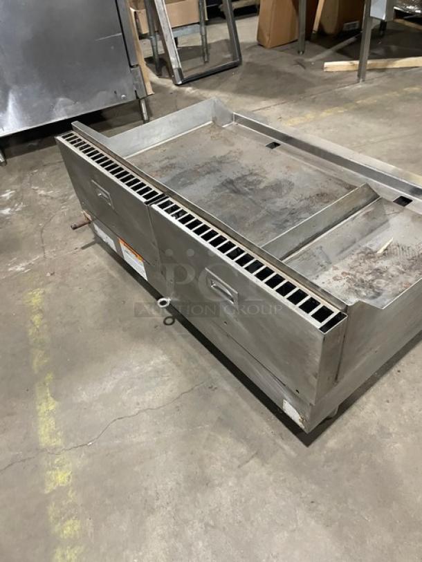 WoodStone commercial stainless steel gas countertop split-top grill with backsplash. Visible wear; sturdy metal legs.
