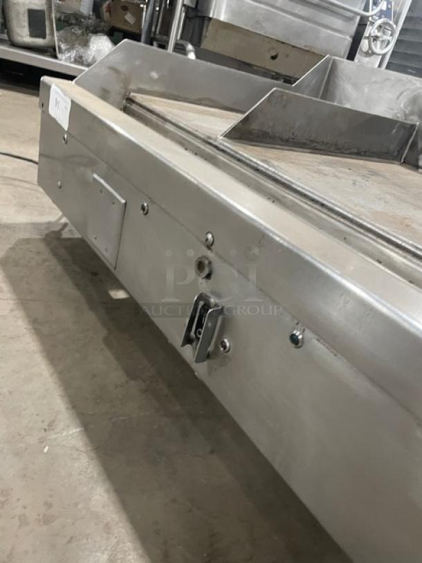WoodStone commercial stainless steel countertop split top flat grill with backsplash, natural gas powered, on legs, in used condition.