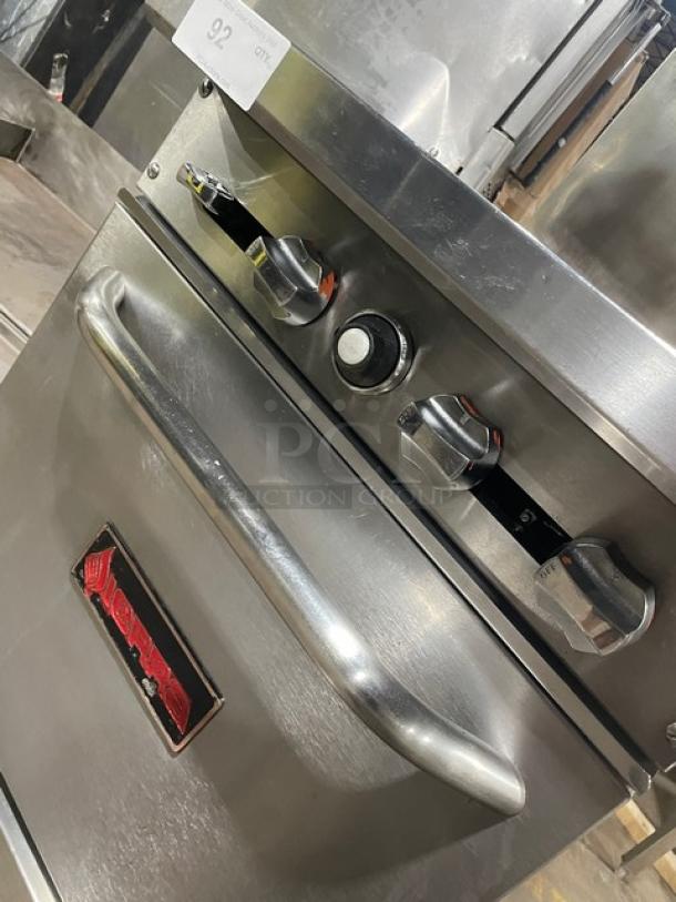 Sierra stainless steel four-burner range/oven combo with backsplash, overhead salamander shelf, and wire oven rack.