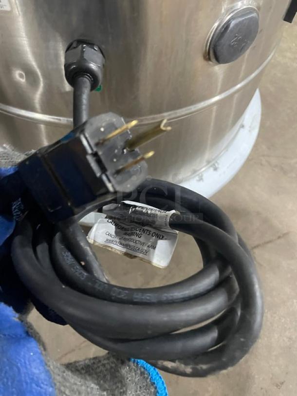 Omcan PE-BR-0010 stainless steel electric potato peeler, heavy-duty, 110v, with plug and power cord, on legs, model label visible.