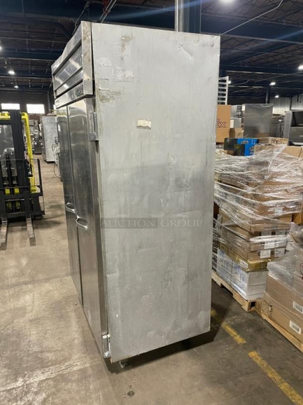 Commercial stainless steel two-door reach-in refrigerator, Traulsen model 1RLT232NUT, used condition, on legs.
