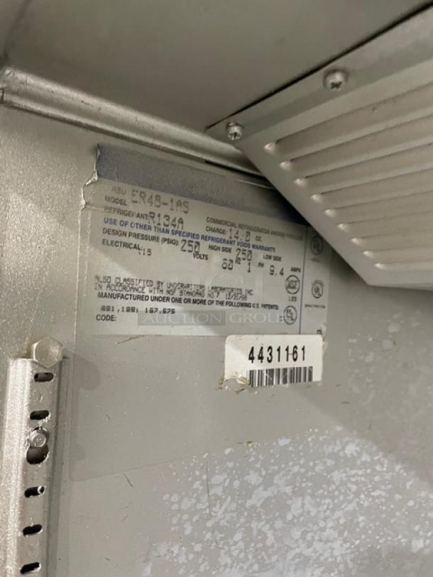 Beverage Air E-series commercial refrigerator, model ER48-1A5, stainless steel, with tags showing series 4431161, on legs.