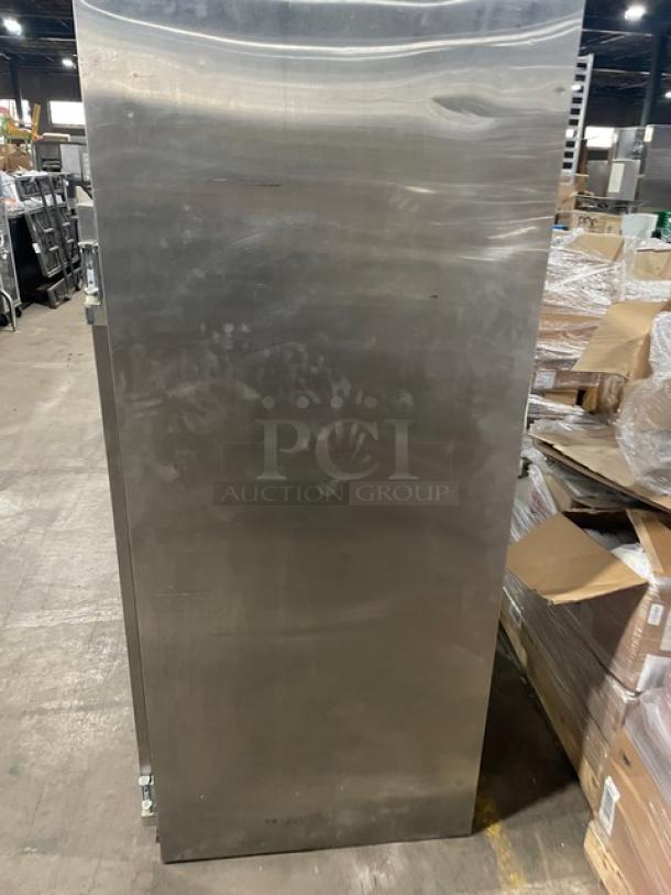 Traulsen stainless steel two-door freezer, model 1RLT232NUT1. Features built-in pan slides, 115V, 1 phase. Signs of use visible.