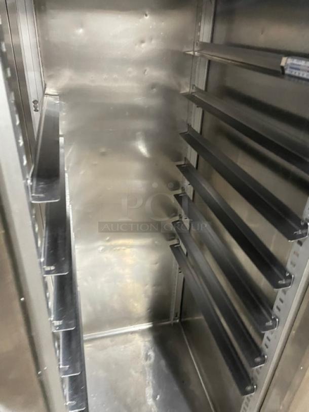 Traulsen commercial stainless steel two-door freezer, Model 1RLT232NUT1, with built-in pan slides, interior view.