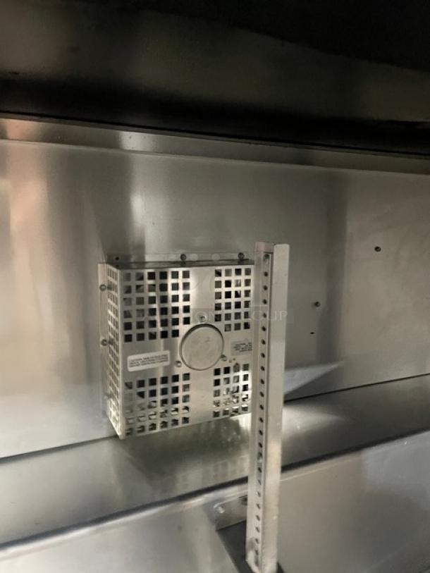 True TUC-60F commercial two-door under-counter worktop freezer interior, stainless steel, model label visible.