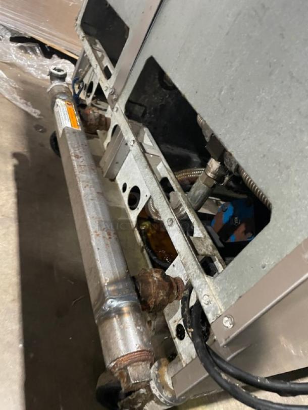 Pitco Solstice Supreme SSH55 stainless steel natural gas 2-bay deep fat fryer, 50 lb capacity, on casters, visible plumbing components.