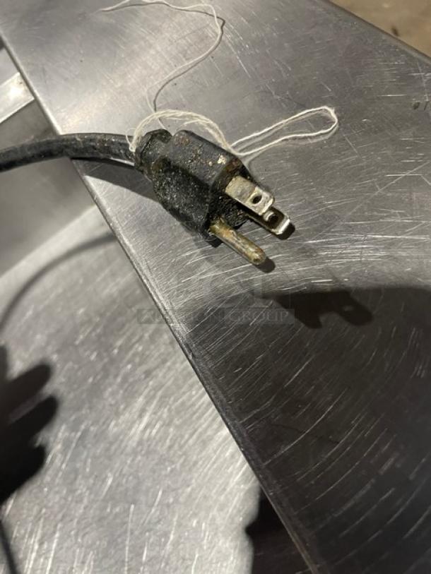 Close-up of the plug end of a Pitco Solstice Supreme SSH55 deep fat fryer, showing wear on the prongs.