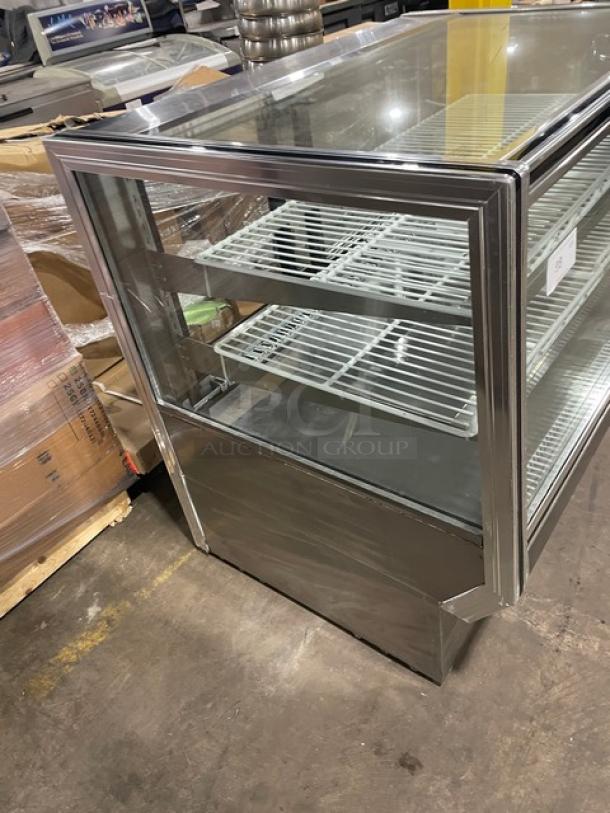 Leader late model stainless steel refrigerated bakery display case with straight glass and poly coated wire racks.
