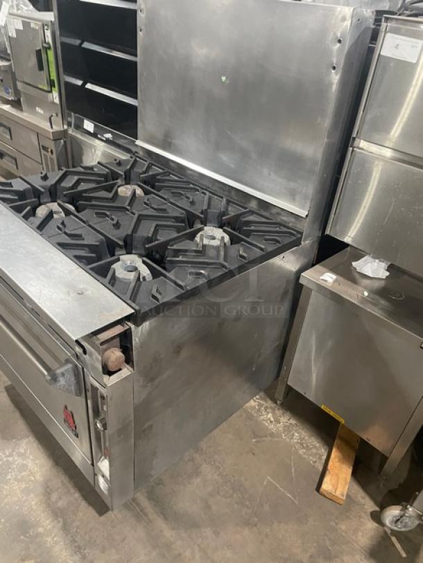 Wolf commercial stainless steel natural gas 4-burner range/oven combo with backsplash and wire oven rack. Used condition.