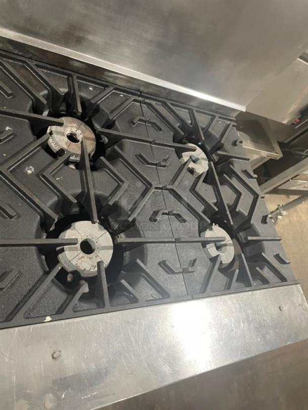 Wolf commercial stainless steel 4-burner natural gas range/oven combo with backsplash and wire oven rack. Working condition.