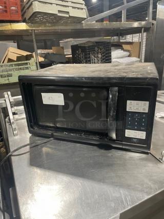 Oster Commercial Black Countertop Microwave Oven, Model OGZJ1104, features digital controls, used condition, 120V 1 Phase.