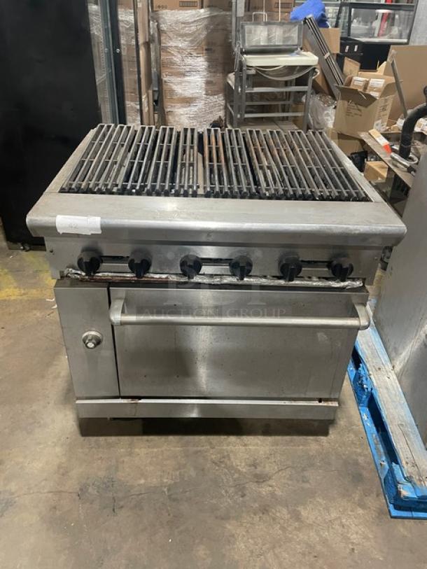 Commercial stainless steel natural gas char broiler range/oven combo with wired rack, four knobs, and robust build.