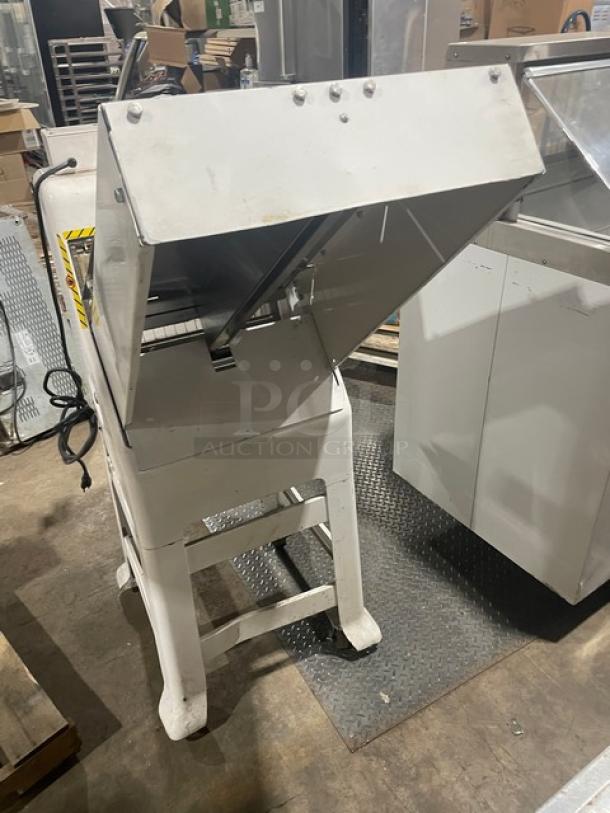 Oliver Model 79732NC gravity feed bread slicer, white, stainless steel worktop, on casters, 115V, shown in used condition.