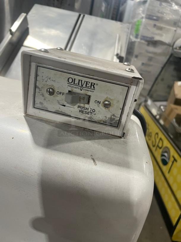 Oliver 797-32-NC Commercial Bread Slicer, electric-powered, gravity feed, stainless steel worktop, on casters.