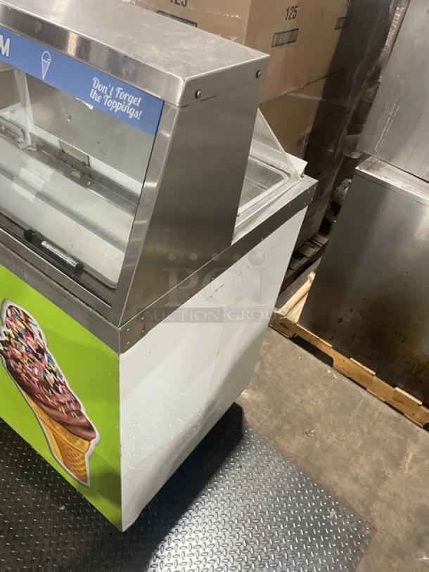 Master-Bilt white ice cream dipping cabinet with serve-over sneeze guard, rear lift-open access, and poly-coated wire rack.